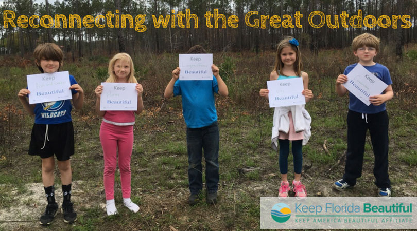 Image of children holding signs that say Keep Florida Beautiful with the text Reconnecting with the Great Outdoors | Keep Florida Beautiful Blog